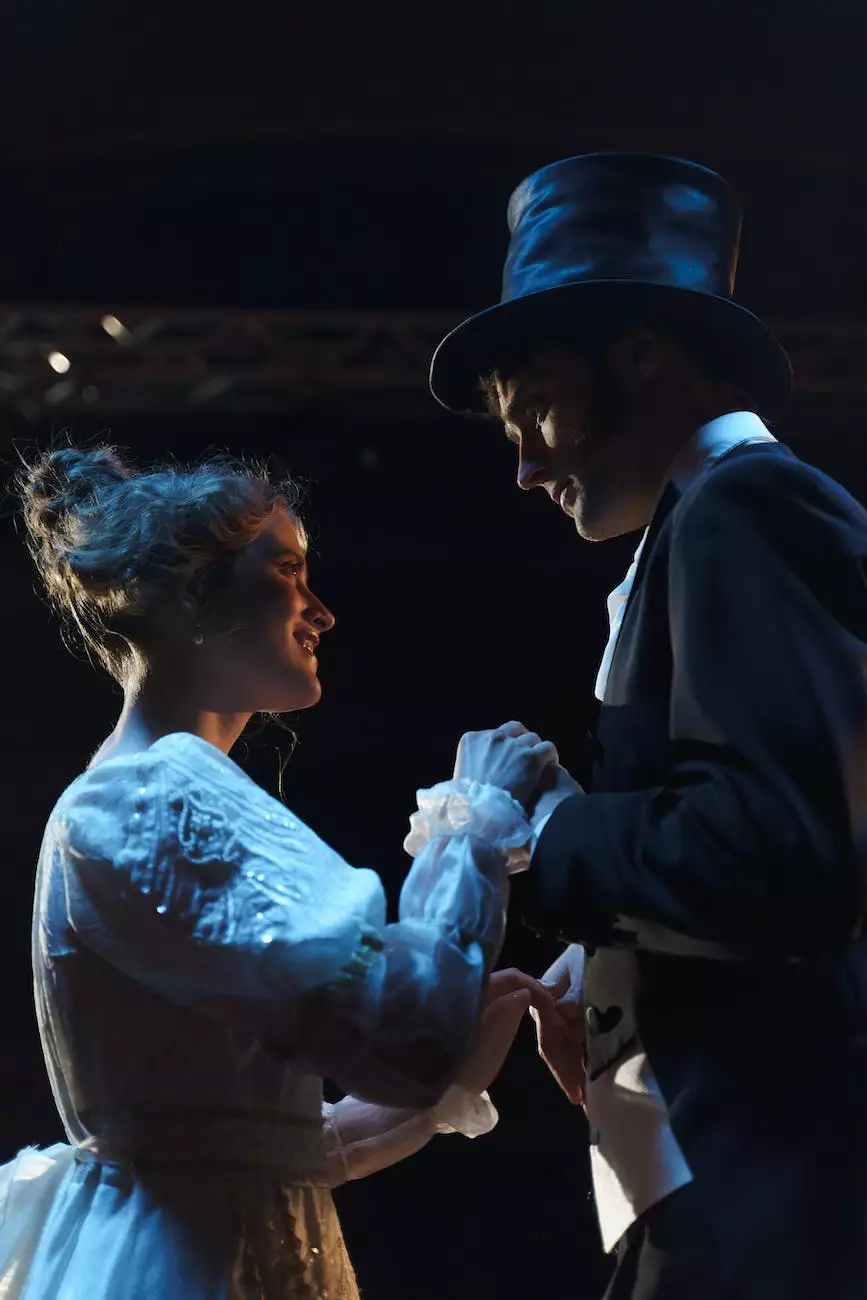 Two costumed performers in a softly lit theatrical scene